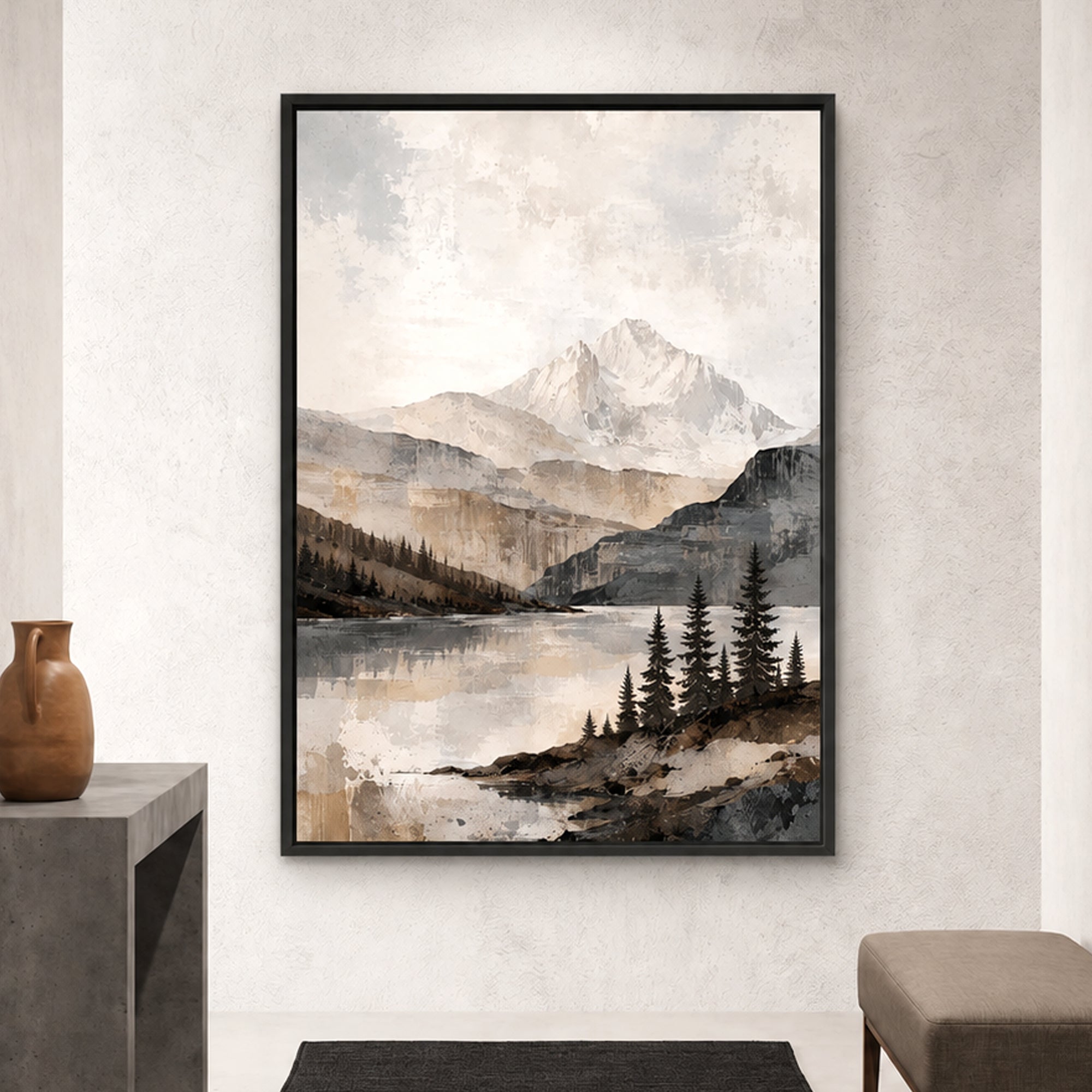 A framed landscape art print featuring a snow-capped mountain, forest, and reflective lake, displayed on a textured light gray wall above a dark rug, with a small vase on the left and a stool on the right.