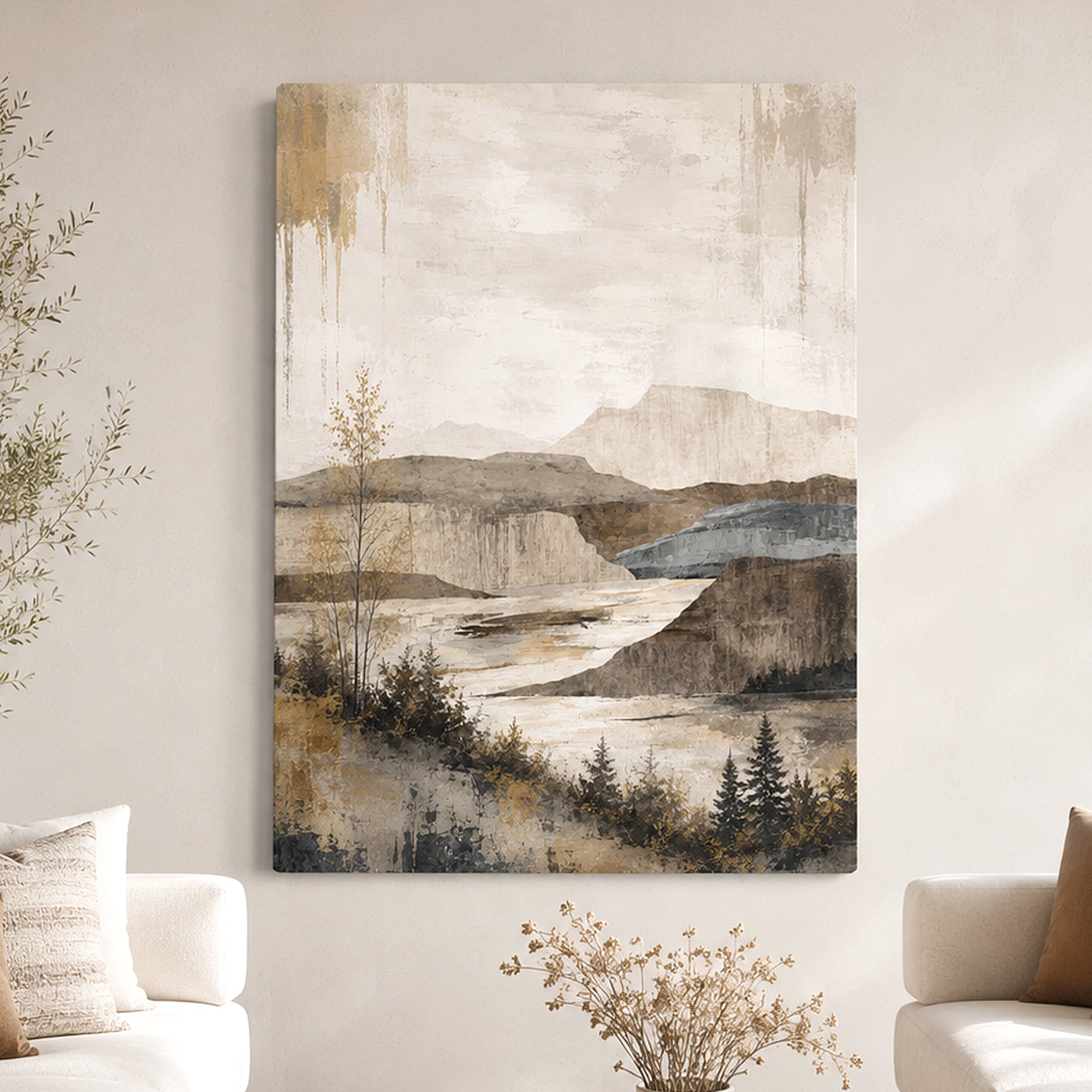 A vertical canvas wall art print featuring an abstract landscape painting with mountains, cliffs, and trees in muted beige, brown, gray, and blue tones, displayed on a light wall above a sofa in a living room setting.