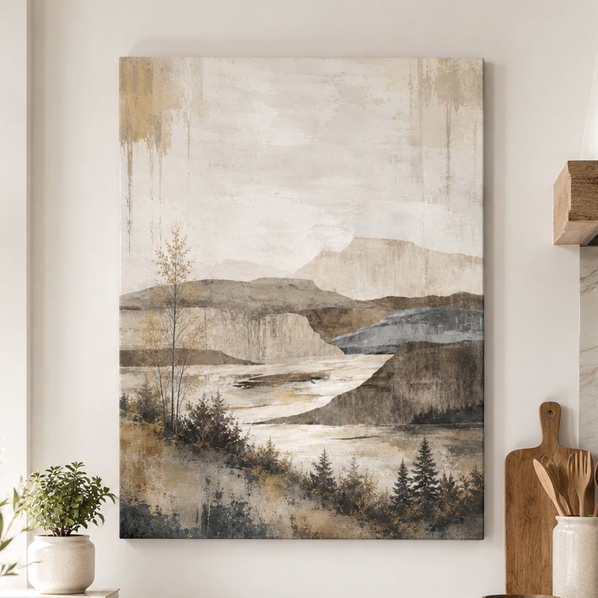 A vertical canvas wall art print featuring an abstract landscape painting with mountains, a river, and trees in muted beige, brown, gray, and blue tones, displayed on a light wall in a styled interior setting.